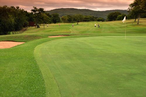 a group of people playing golf on a golf course at Kruger Park Lodge Unit No. 277 in Hazyview