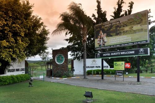 a sign in front of a building with a billboard at Kruger Park Lodge Unit No. 277 in Hazyview