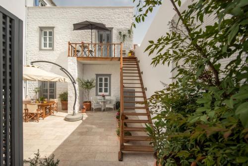 a staircase leading up to a house with a patio at Hydras Chromata in Hydra