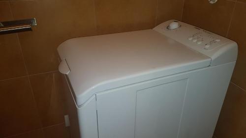 a white washer and dryer in a bathroom at Apartmán U kolonády in Mariánské Lázně