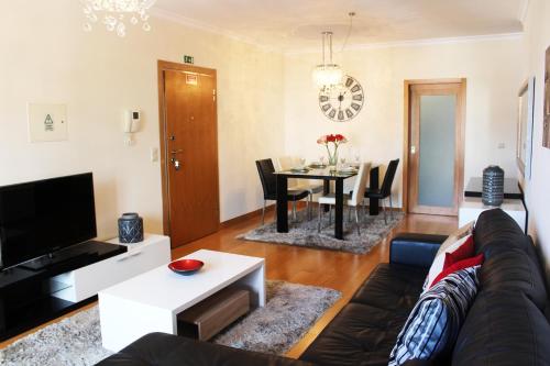 a living room with a couch and a table at MCStylo-Residenza in Funchal