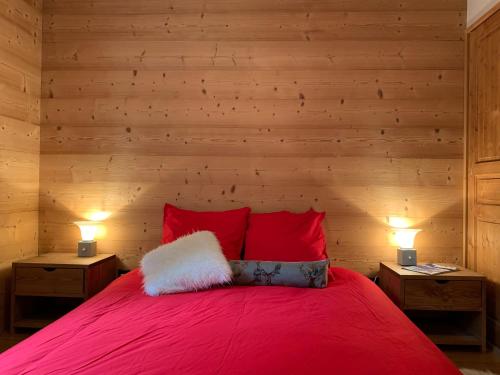 a bedroom with a red bed with two night stands at Residence le Paradis in Chamonix-Mont-Blanc