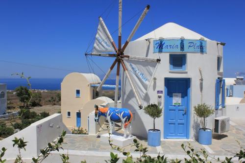a house with a surfboard on top of it at Maria's Place - Adults Only in Oia