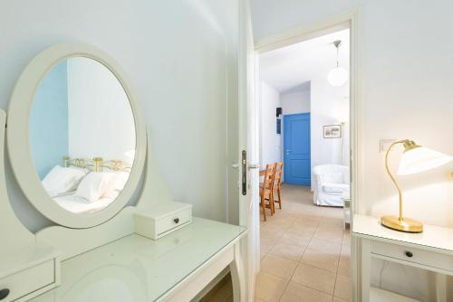 a bedroom with a mirror and a bed in a room at Kostantis Vacation Home 1 in Ambelas