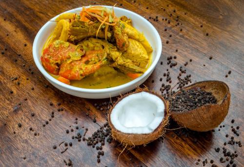 a bowl of food on a wooden table at Beyt Al Salaam in Zanzibar City