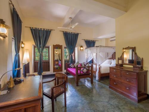 a bedroom with a bed and a dresser with a mirror at Beyt Al Salaam in Zanzibar City