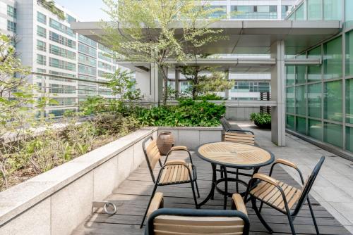 a patio with a table and chairs on a building at Hotel Atrium Jongno in Seoul