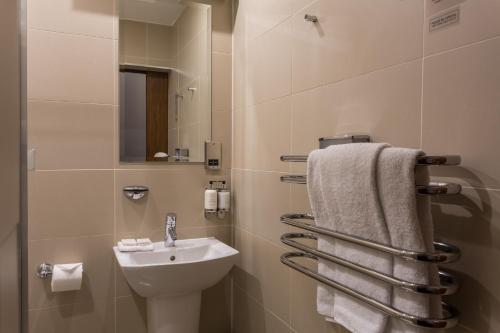a small bathroom with a sink and a toilet at Angels Share Hotel in Edinburgh