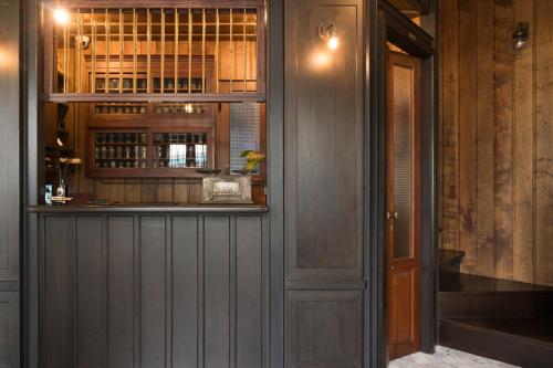 a bar in a room with a window and a door at 1905 Heritage Corner in Bangkok