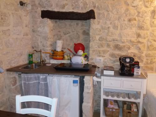 a small kitchen with a counter and a sink at Il Castello in Casamassima