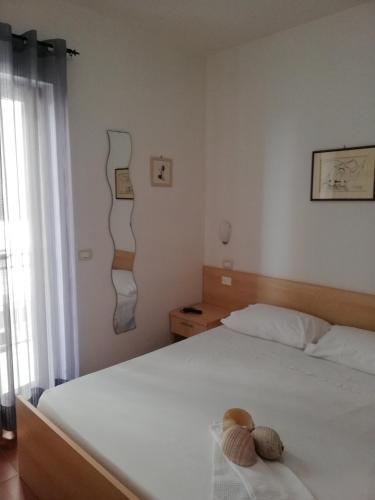 a bedroom with a bed with a stuffed animal on it at b&b divaresidence in Margherita di Savoia
