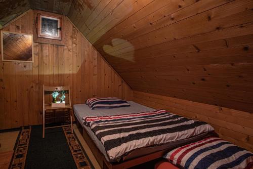 a bedroom with a bed in a wooden cabin at Chalet Gasparjeva Velika Planina in Kamnik
