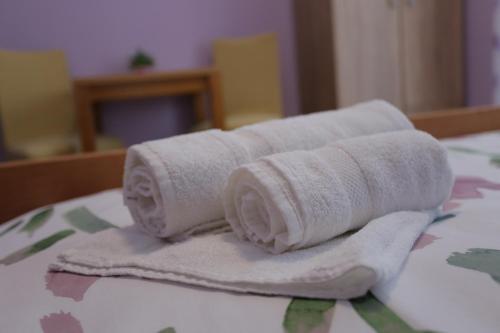a pile of towels sitting on top of a bed at APARTMANI KSENIJA in Krapinske Toplice