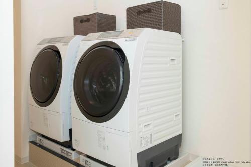 two washing machines stacked on top of each other at Framboise KYOTO Hotel de charme in Kyoto