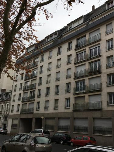 a large building with cars parked in front of it at Les Beaux Jours, Tours in Tours