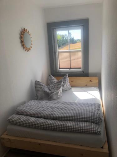 a bed in a room with a window at Landgasthof Wetteraperle in Raila