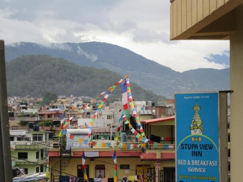 a group of flags on the roofs of a city at STUPA VIEW INN in Kathmandu