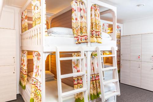 a bunk bed in a room with shelves at Hostel na Nevskom Mishanya in Saint Petersburg