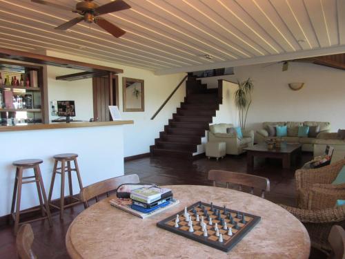 a living room with a table with a chess board on it at Pousada Encanto de Búzios in Búzios