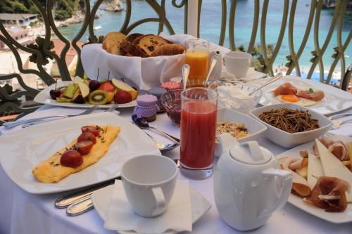 a table with plates of food and drinks on it at Irida Parga in Parga