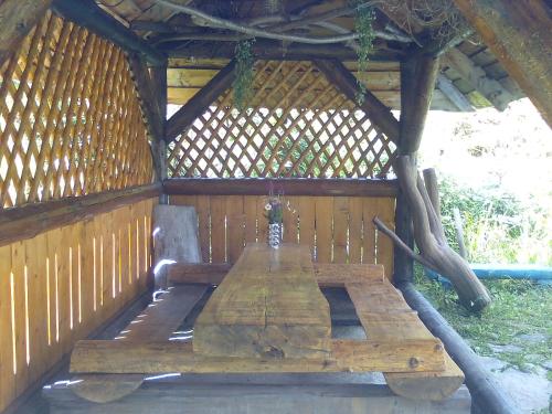a wooden table in a gazebo at PetrikHolm in Tatariv