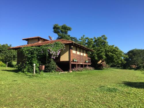 a house in the middle of a grass field at Hotel Santa Esmeralda in Bonito