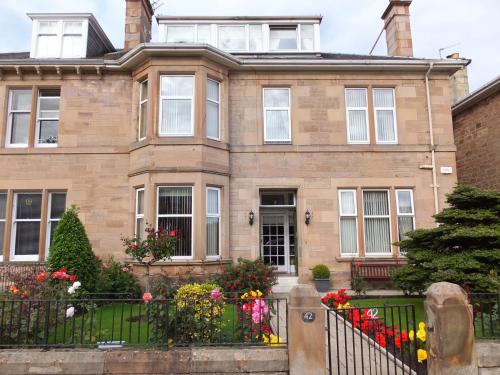 a house with flowers in front of it at Inverlea Guest House in Ayr