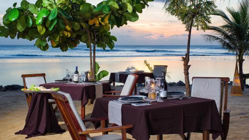 a table set up on a beach with the ocean at My Blue Hotel in Jericoacoara