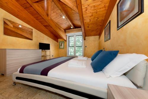 a large bedroom with a large bed with blue pillows at Casa da Suite Maestosa in Sesto San Giovanni