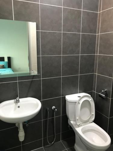 a bathroom with a toilet and a sink at The Zizz Homestay@Damansara Damai in Petaling Jaya