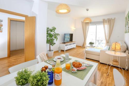 a living room with a table with food on it at Apartamento L&G Centro in Ayamonte