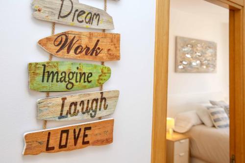 a bunch of wooden signs hanging on a wall at Apartamento L&G Centro in Ayamonte