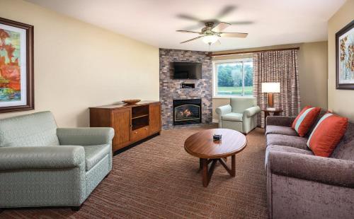 a living room filled with furniture and a fire place at Club Wyndham Tamarack in Wisconsin Dells