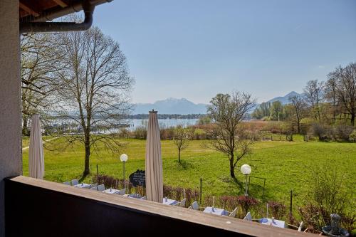 a window with a view of a green field at Zum Fischer am See ***S in Prien am Chiemsee