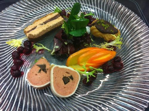 a plate of food with vegetables and bread on it at Zum Fischer am See ***S in Prien am Chiemsee