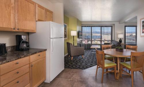 a kitchen with a refrigerator and a table with chairs at WorldMark Reno in Reno