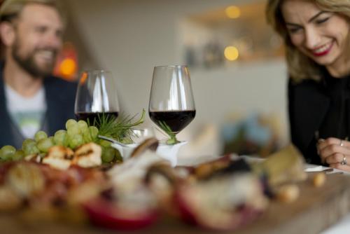 a woman and a man sitting at a table with wine glasses at Grand Hotel Admiral Palace in Chianciano Terme