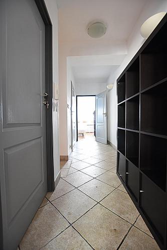 an empty hallway with a door and a tile floor at Mhost Bronowice in Kraków