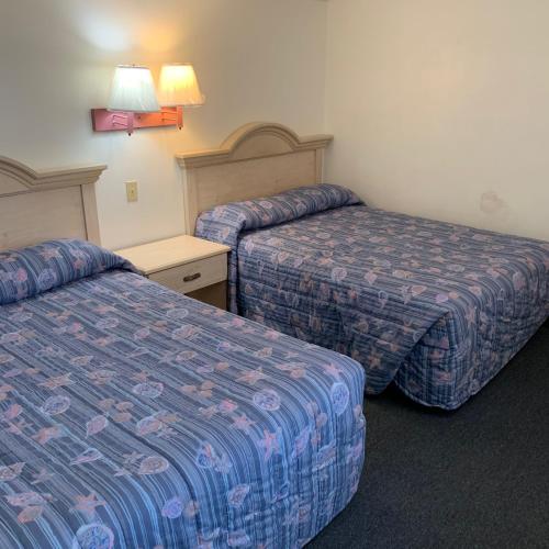 a hotel room with two beds in a room at Roman Holiday Resort in North Wildwood