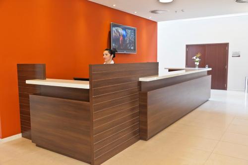 a woman sitting at a reception desk in a lobby at Hotel Panamby São Paulo in Sao Paulo