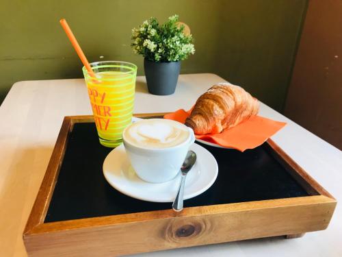 a tray with a cup of coffee and a croissant on a table at Al Vicolo Stretto in Santa Maria a Vico