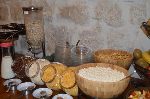 a table with bowls of oats and other food at Hotel Villa Diana in Split