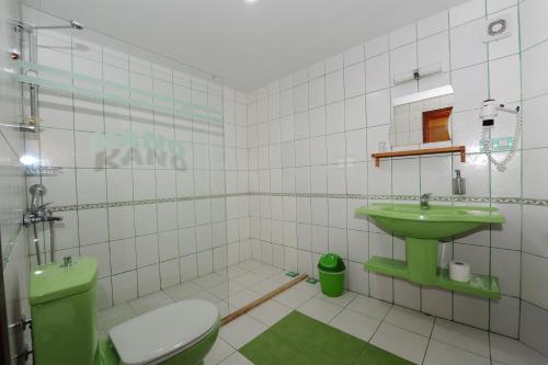 La salle de bains est pourvue d'un lavabo vert et de toilettes. dans l'établissement Kano Hotel, à Dalyan