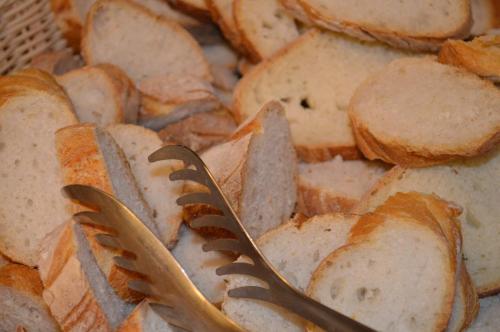 two plastic forks sitting on top of bread at Hotel Villa Diana in Split