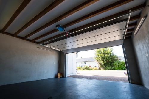 an empty garage with a large window and a door at Bütgenbach Ferienhaus Lorea in Butgenbach