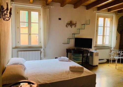 a bedroom with a bed and a tv and stairs at whouse suite GOLD TOWERS in Bologna