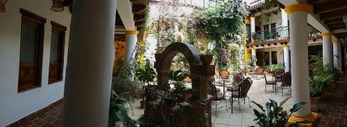 a courtyard with chairs and plants in a building at Hotel Grand Maria in San Cristóbal de Las Casas