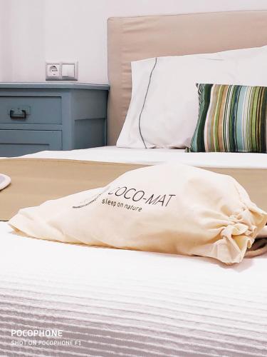 a pillow on a bed in a bedroom at Gerani Deluxe Houses in Astypalaia Town