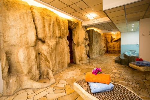 a bathroom with a large rock wall at Hotel Tritone Lipari in Lipari