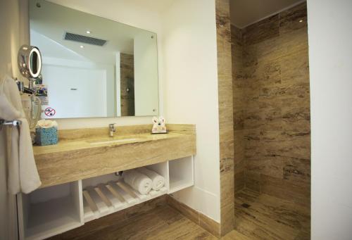 a bathroom with a sink and a mirror at Viva Tangerine by Wyndham, A Trademark All Inclusive in Cabarete